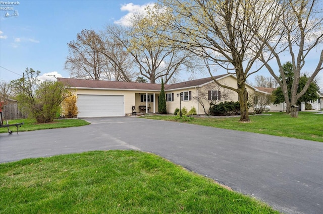 5191 N State Route 53, Tiffin, OH 44883 - ranch-style house with an attached garage, driveway, and a front yard