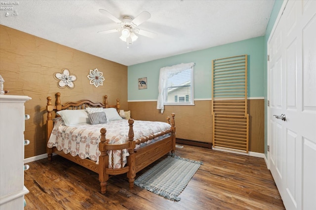 5191 N State Route 53, Tiffin, OH 44883 - bedroom featuring wood finished floors, wainscoting, ceiling fan, a textured ceiling, and a closet