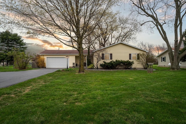 5191 N State Route 53, Tiffin, OH 44883 - view of front facade with asphalt driveway, a garage, and a front lawn
