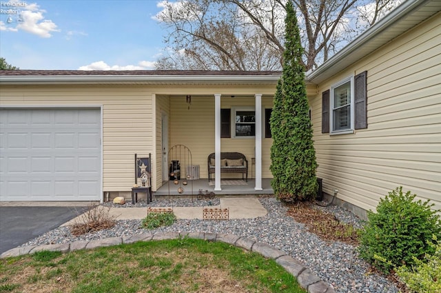 5191 N State Route 53, Tiffin, OH 44883 - doorway to property featuring a porch, an attached garage, and asphalt driveway