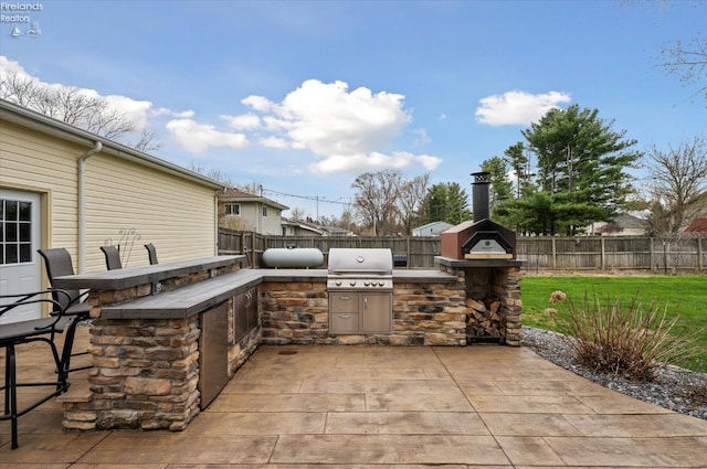 5191 N State Route 53, Tiffin, OH 44883 - fenced backyard featuring exterior kitchen and a patio