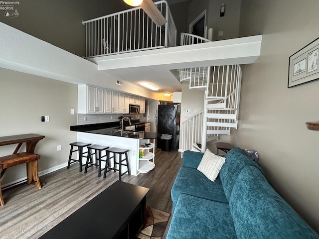 400 Swartz Ln Unit Y306, Middle Bass Island, OH 43446 - living area with stairs, a high ceiling, and dark wood-type flooring
