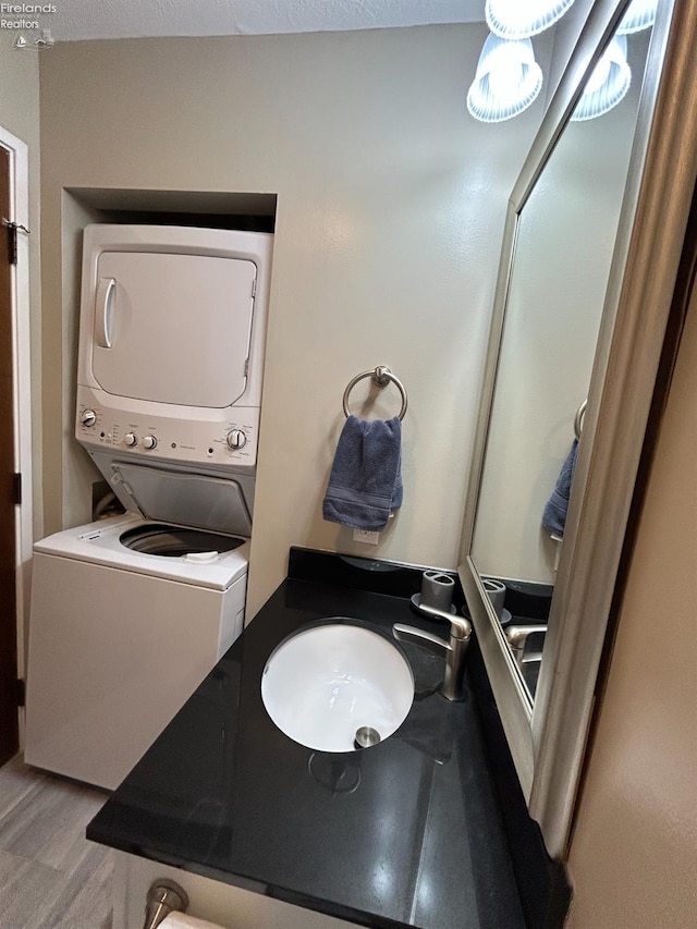 400 Swartz Ln Unit Y306, Middle Bass Island, OH 43446 - bathroom featuring stacked washer and clothes dryer and wood finished floors