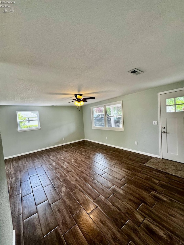 2150 Aspen Run, Sandusky, OH 44870 - unfurnished room with wood tiled floors, a textured ceiling, a ceiling fan, and healthy amount of natural light