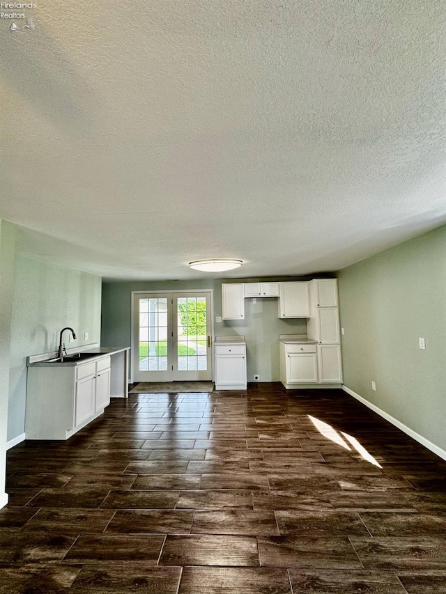 2150 Aspen Run, Sandusky, OH 44870 - unfurnished living room with wood tiled floors and a textured ceiling