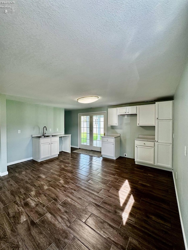 2150 Aspen Run, Sandusky, OH 44870 - unfurnished living room with a textured ceiling and wood tiled floors