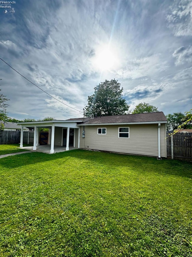 2150 Aspen Run, Sandusky, OH 44870 - rear view of house featuring a patio and a carport