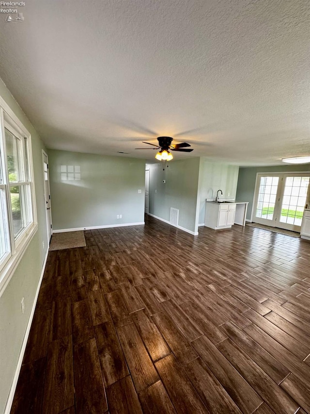2150 Aspen Run, Sandusky, OH 44870 - unfurnished living room featuring dark wood-style flooring, a ceiling fan, and a textured ceiling