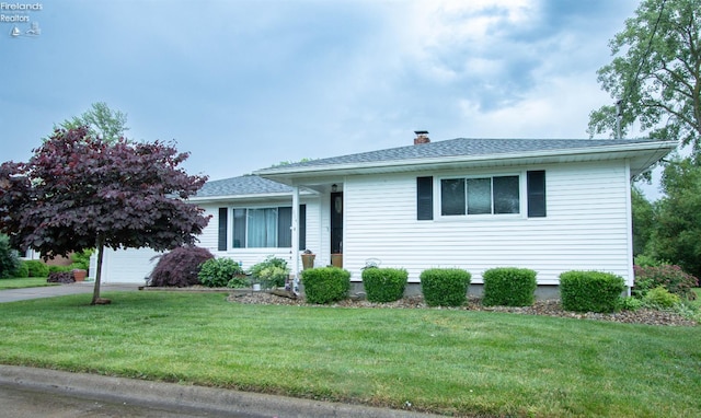 214 1st, Huron, OH 44839 - view of front facade with a chimney, a front lawn, and a shingled roof