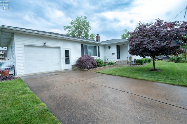 214 1st, Huron, OH 44839 - single story home with an attached garage, a chimney, driveway, and a front yard