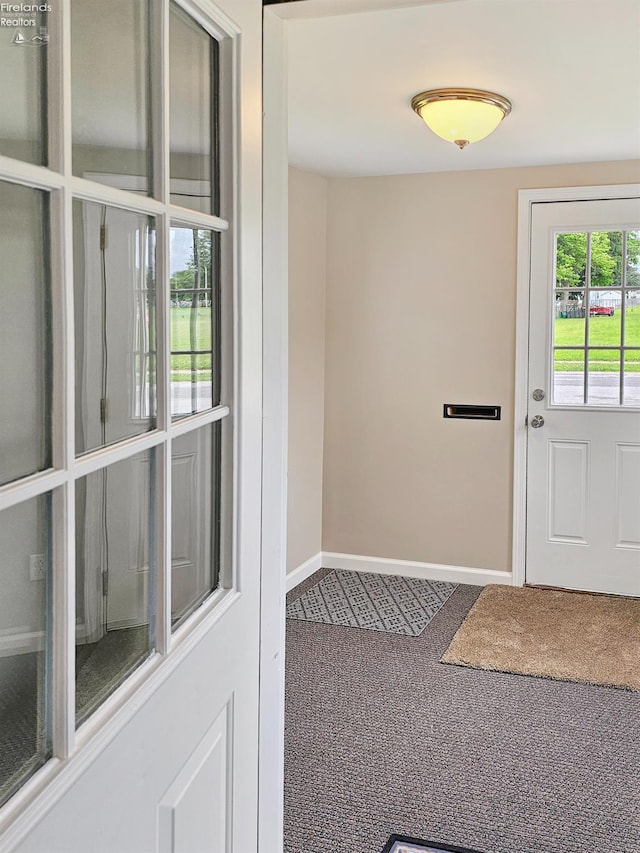 217 Ott St, Clyde, OH 43410 - doorway to outside with carpet flooring and baseboards