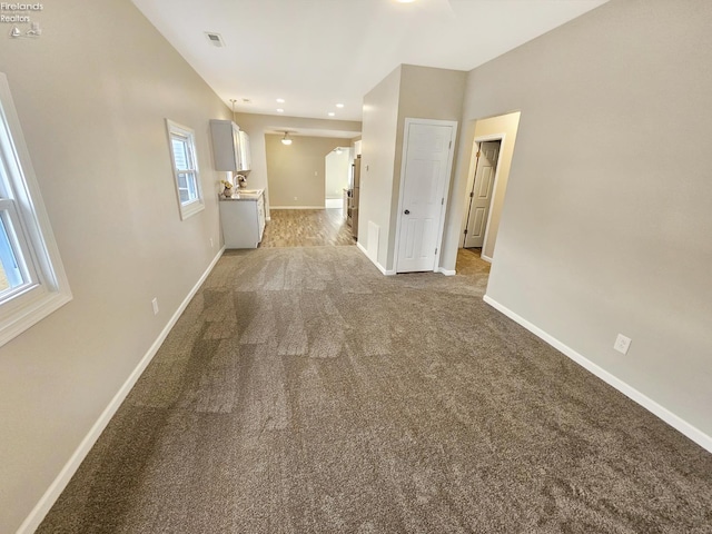 217 Ott St, Clyde, OH 43410 - unfurnished living room featuring light colored carpet and recessed lighting