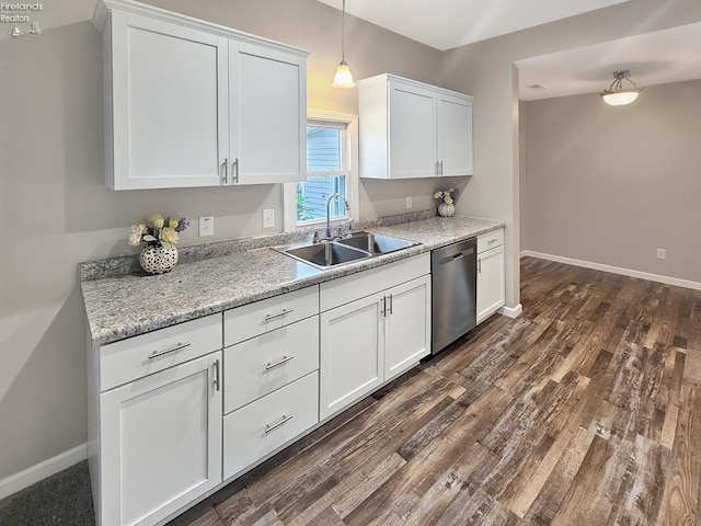 217 Ott St, Clyde, OH 43410 - kitchen featuring stainless steel dishwasher, white cabinets, dark wood finished floors, pendant lighting, and light stone countertops