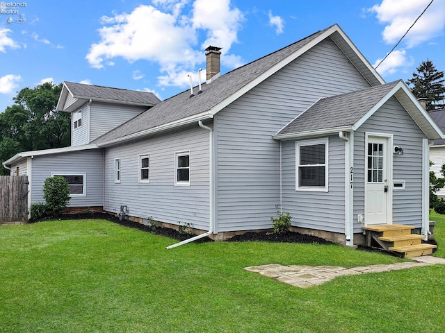 217 Ott St, Clyde, OH 43410 - back of house with a chimney and roof with shingles