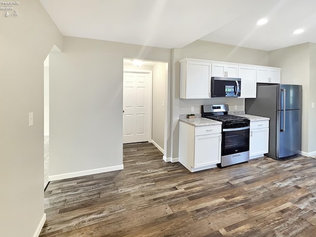 217 Ott St, Clyde, OH 43410 - kitchen featuring stainless steel appliances, dark wood-type flooring, white cabinets, recessed lighting, and light stone countertops