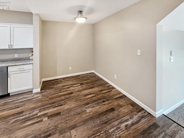 217 Ott St, Clyde, OH 43410 - unfurnished dining area with dark wood-style floors and baseboards