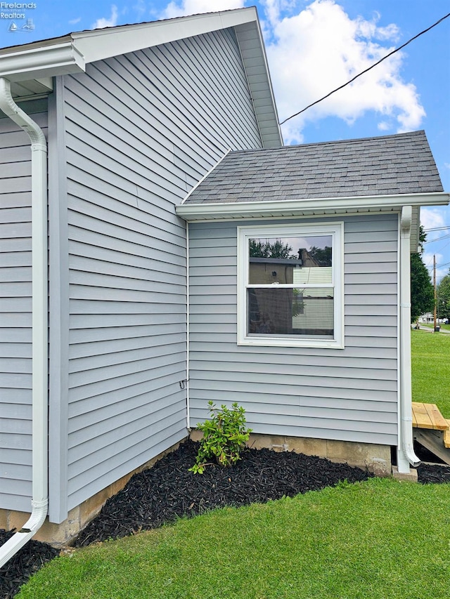 217 Ott St, Clyde, OH 43410 - view of property exterior featuring a shingled roof and a yard