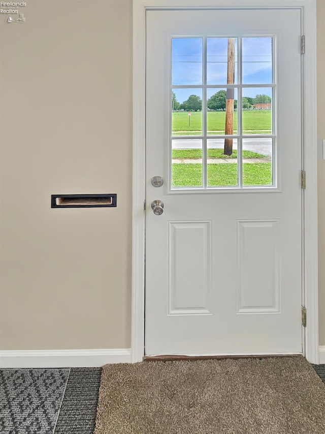 217 Ott St, Clyde, OH 43410 - doorway with baseboards and carpet flooring