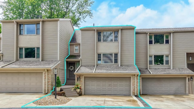 3616 Turfside Cir Unit B, Huron, OH 44839 - townhome / multi-family property featuring an attached garage, driveway, and brick siding