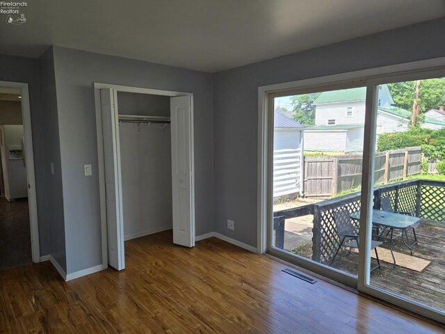 519 Howard St, Findlay, OH 45840 - unfurnished bedroom with white fridge with ice dispenser, wood finished floors, access to outside, and a closet