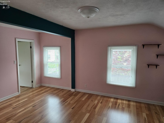 519 Howard St, Findlay, OH 45840 - unfurnished room with wood finished floors, plenty of natural light, and a textured ceiling