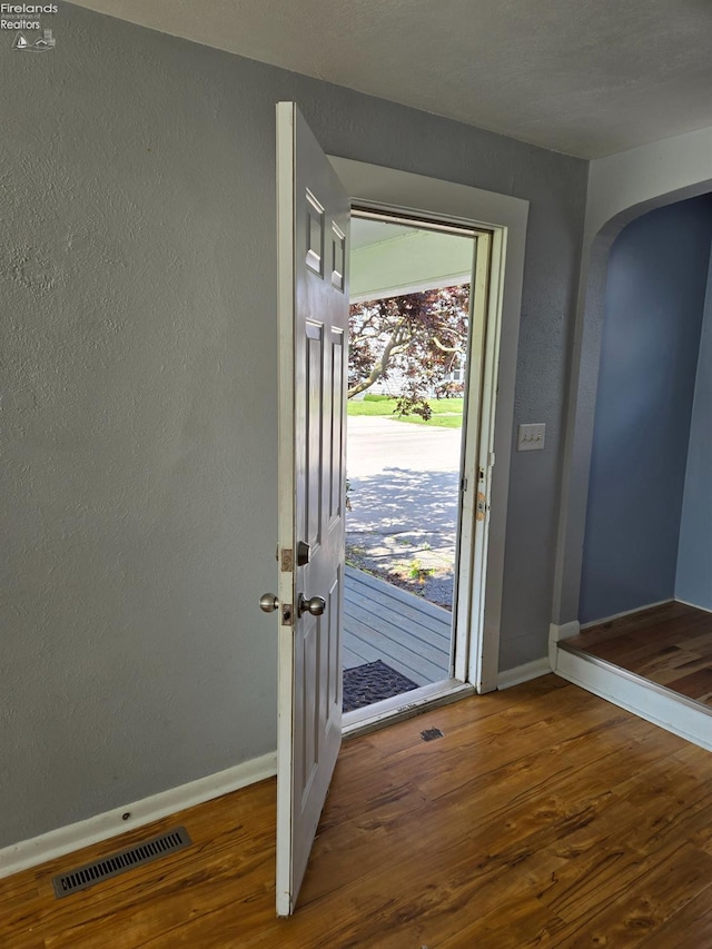 519 Howard St, Findlay, OH 45840 - entryway featuring wood finished floors, arched walkways, and a textured wall