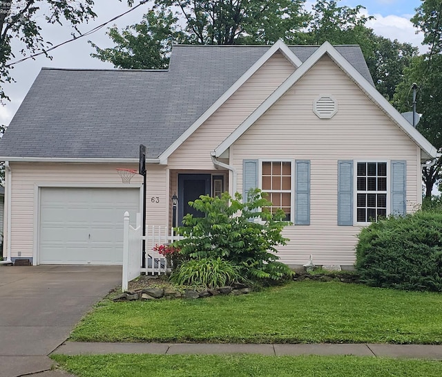 63 Williams Ave, Norwalk, OH 44857 - view of front facade featuring a garage, a front yard, and concrete driveway