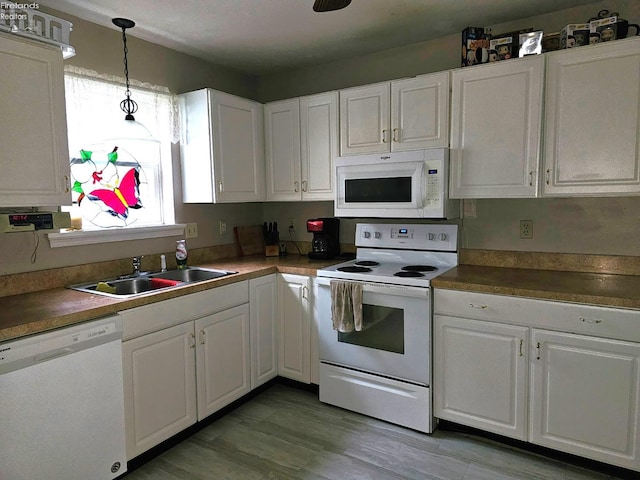 63 Williams Ave, Norwalk, OH 44857 - kitchen with white appliances, white cabinetry, pendant lighting, and light wood-style flooring