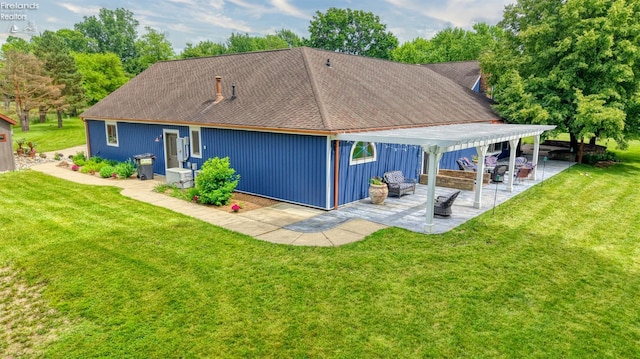 500 E State Route 61, Norwalk, OH 44857 - rear view of property featuring a patio, a lawn, and a shingled roof