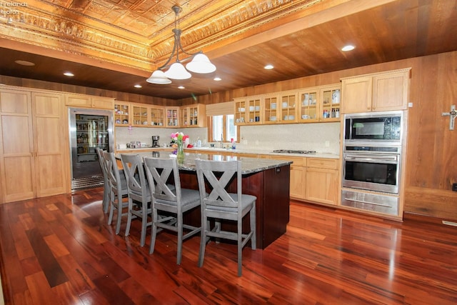 500 E State Route 61, Norwalk, OH 44857 - kitchen with stainless steel appliances, a warming drawer, a kitchen island, dark wood-style flooring, and an ornate ceiling
