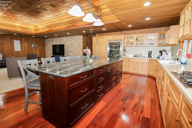 500 E State Route 61, Norwalk, OH 44857 - kitchen featuring open floor plan, a breakfast bar area, dark wood-style flooring, a kitchen island, and an ornate ceiling