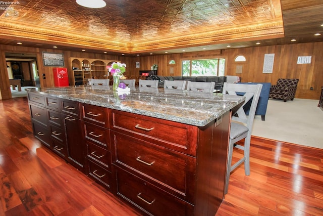 500 E State Route 61, Norwalk, OH 44857 - kitchen featuring an ornate ceiling, dark brown cabinets, a kitchen breakfast bar, wood finished floors, and light stone countertops