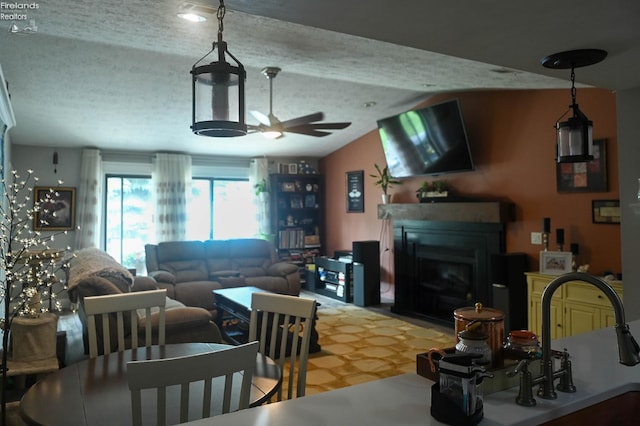 423 Leisure Dr, Huron, OH 44839 - living room featuring a ceiling fan, lofted ceiling, a textured ceiling, and a fireplace