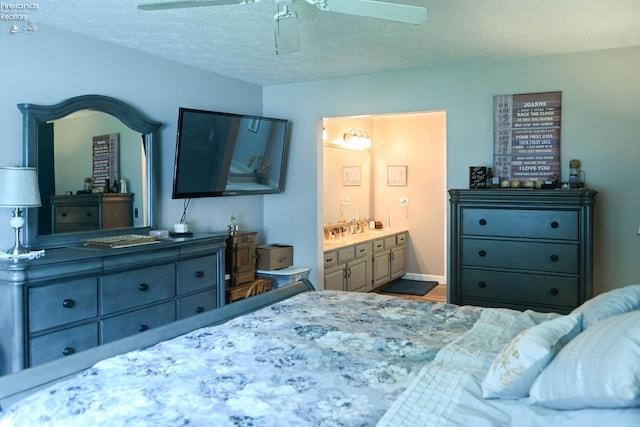 423 Leisure Dr, Huron, OH 44839 - bedroom with ensuite bathroom, ceiling fan, and a textured ceiling