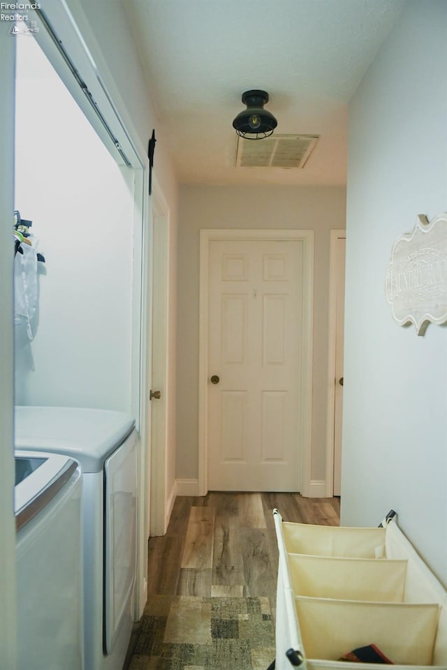 423 Leisure Dr, Huron, OH 44839 - washroom with separate washer and dryer and wood finished floors