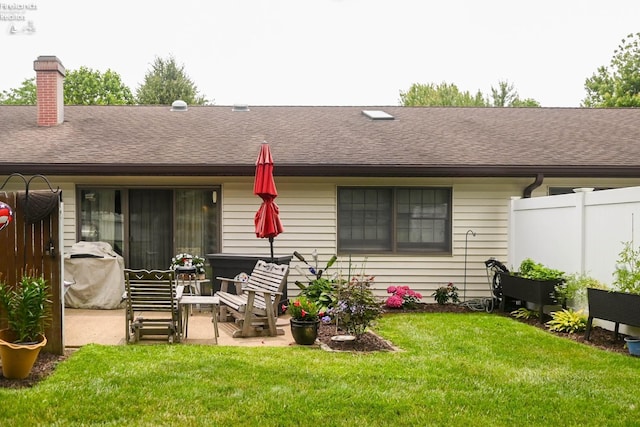 423 Leisure Dr, Huron, OH 44839 - rear view of property with a shingled roof, a chimney, and a patio