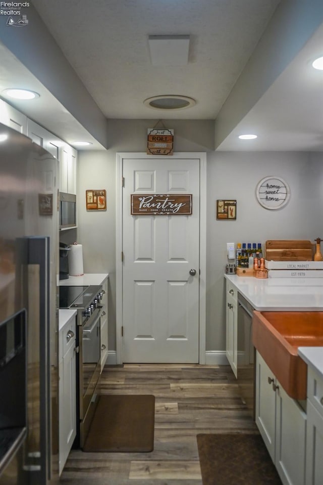 423 Leisure Dr, Huron, OH 44839 - kitchen featuring stainless steel appliances, dark wood-type flooring, light countertops, and recessed lighting