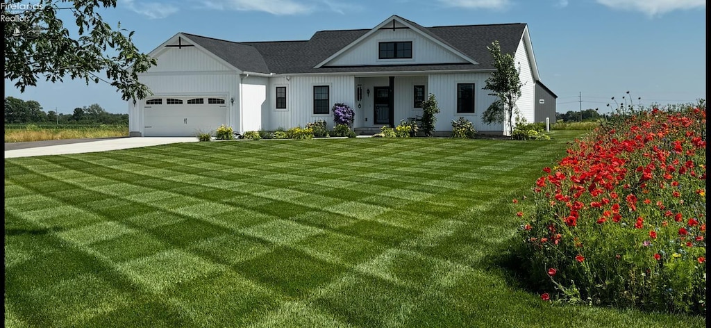 3508 Boos Rd, Huron, OH 44839 - modern farmhouse featuring driveway, a front yard, and a garage