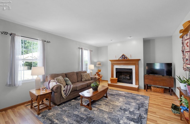 408 Forest St, Lagrange, OH 44050 - living area with plenty of natural light, wood finished floors, and a premium fireplace