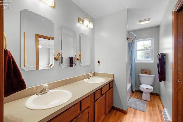 408 Forest St, Lagrange, OH 44050 - bathroom with a baseboard radiator, wood finished floors, double vanity, and shower / bath combination with curtain