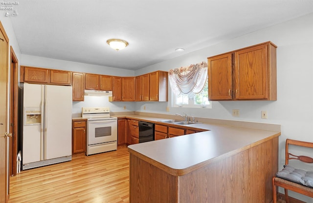 408 Forest St, Lagrange, OH 44050 - kitchen with white appliances, under cabinet range hood, light wood-style flooring, brown cabinets, and recessed lighting