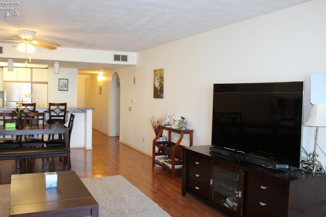1507 Cleveland Rd Unit 423, Huron, OH 44839 - living area featuring arched walkways, a ceiling fan, and wood finished floors