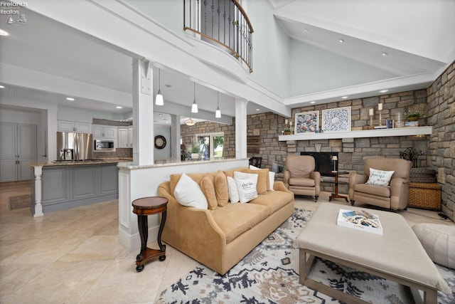 1115 Cedar Point Rd, Sandusky, OH 44870 - living area with a stone fireplace, a high ceiling, light tile patterned floors, and recessed lighting