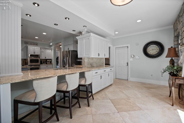 1115 Cedar Point Rd, Sandusky, OH 44870 - kitchen with appliances with stainless steel finishes, recessed lighting, decorative backsplash, white cabinetry, and a peninsula