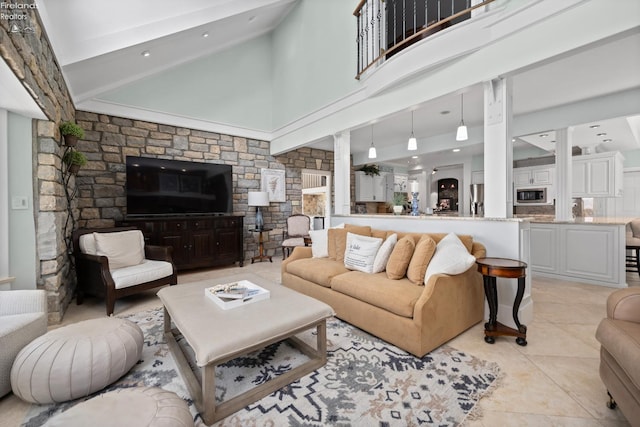 1115 Cedar Point Rd, Sandusky, OH 44870 - living area with high vaulted ceiling, decorative columns, light tile patterned floors, and beam ceiling