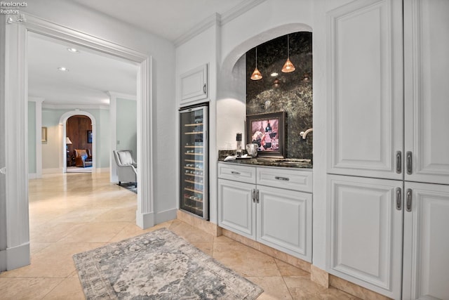 1115 Cedar Point Rd, Sandusky, OH 44870 - indoor bar with arched walkways, wine cooler, ornamental molding, light tile patterned floors, and recessed lighting