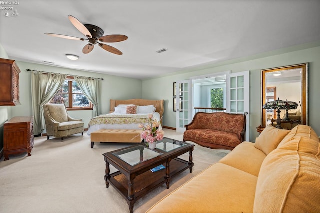 1115 Cedar Point Rd, Sandusky, OH 44870 - bedroom with light carpet, french doors, and a ceiling fan
