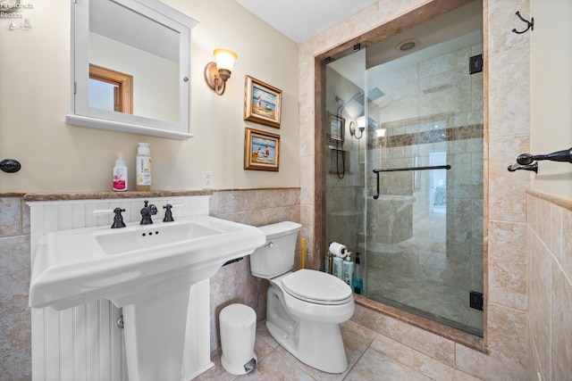 1115 Cedar Point Rd, Sandusky, OH 44870 - full bathroom with tile walls, a stall shower, tile patterned flooring, and wainscoting