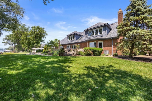 1115 Cedar Point Rd, Sandusky, OH 44870 - rear view of property with a lawn, brick siding, and a chimney