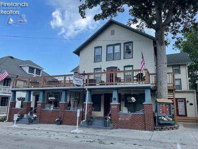 317 Maple Unit 17, Lakeside, OH 43440 - view of front of home with covered porch, brick siding, and a balcony